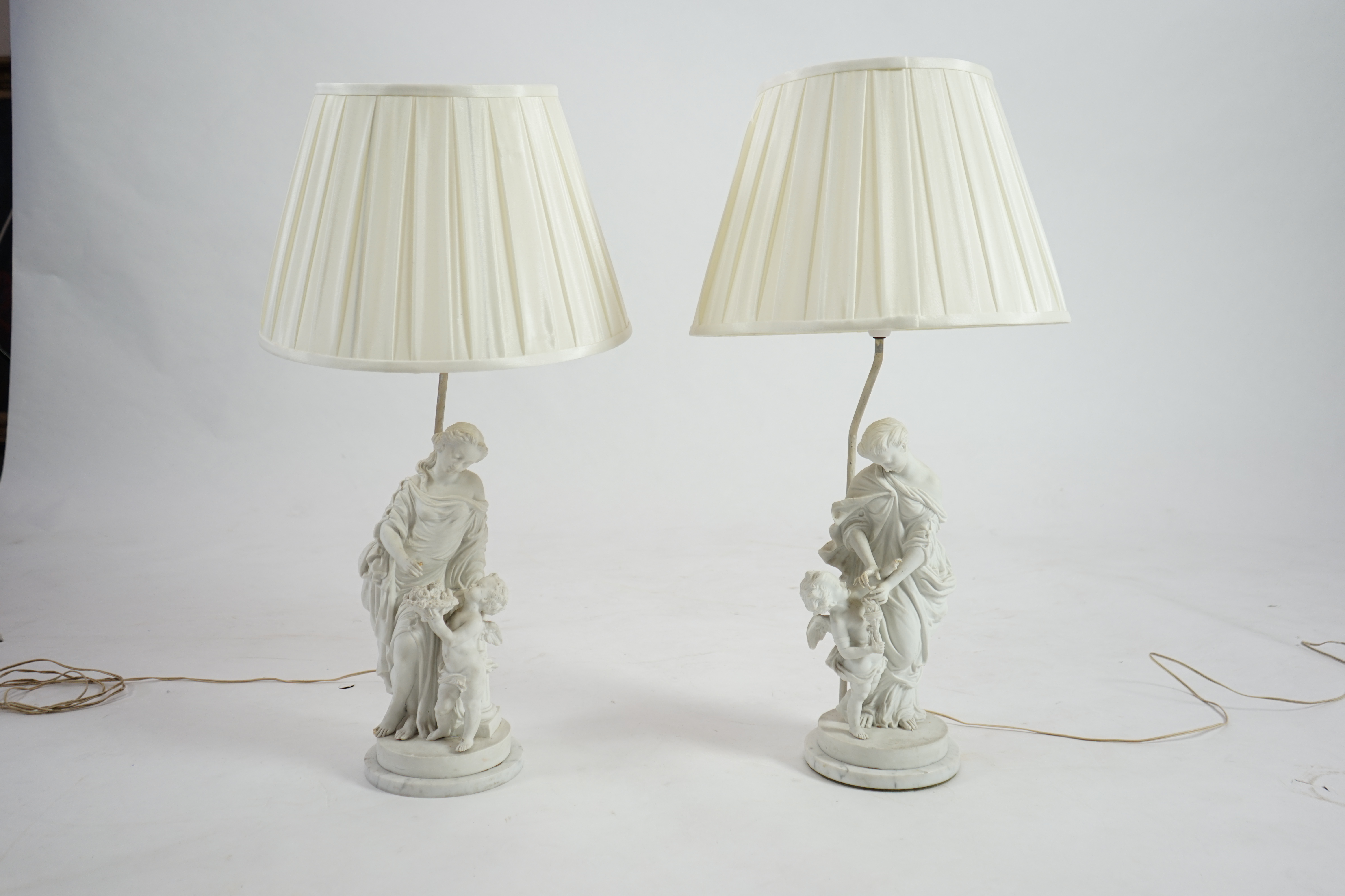 A pair of 19th century French bisque groups, depicting the seasons, Summer and Winter